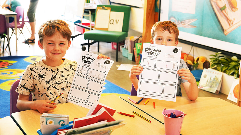 Children holding up their Pyjamarama activity sheets