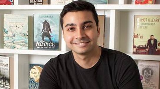 Taran Matharu looking to camera, smiling.