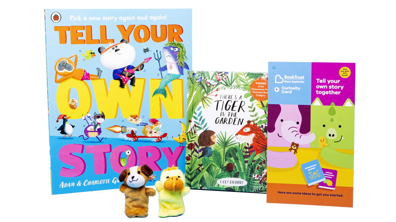 The contents of pack 6, which includes two fuzzy puppet toys and some books.