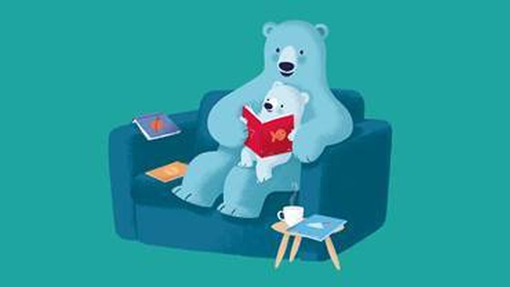 An illustration of a bear reading to their cub sitting on an armchair.