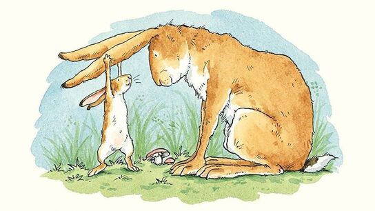 An illustration from the front cover of Guess How Much I Love You - a young rabbit stretching up to tug on the ears of an older smiling rabbit