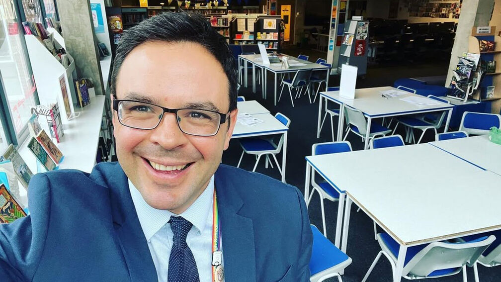 Lucas Maxwell smiling in his school library