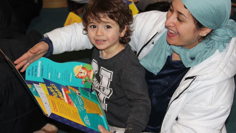 A child and woman enjoying a Bookstart pack together in Slough