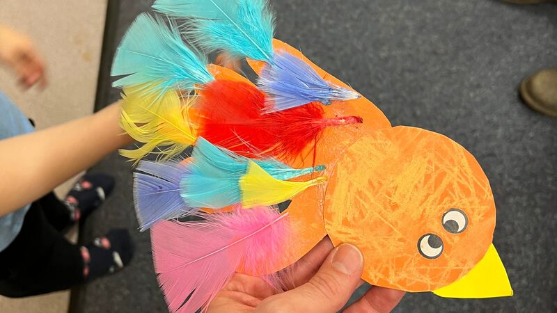 A colourful bird made in a craft session