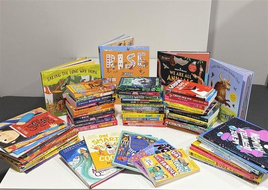 A pile of all 100 books that could be won, placed on a table