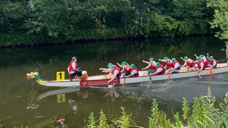 a group of people rowing in a boat in the water