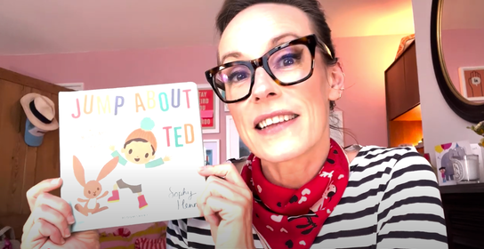 woman holding up book to the camera