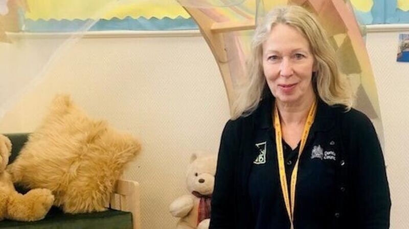 woman sitting down on floor in a library