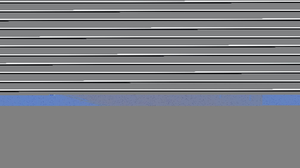 children sitting in a classroom holding up paper certificates