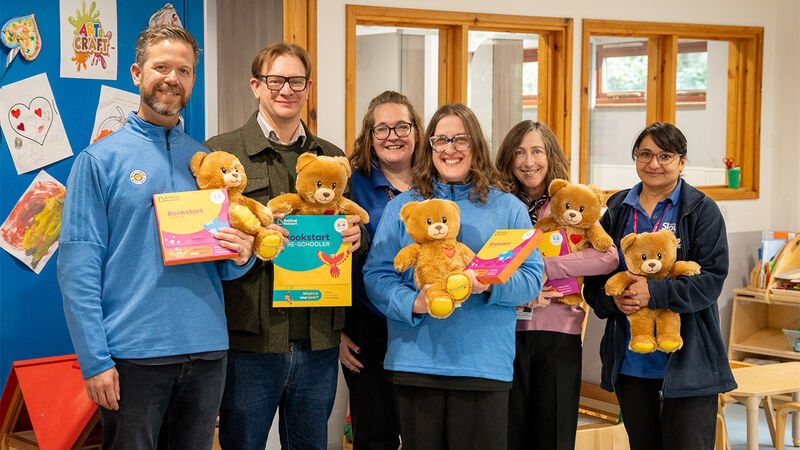 Jonathan from BookTrust (second from left) joins Build-a-Bear staff and nursery staff, holding BookTrust packs and reading bears