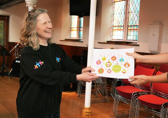 A woman giving out one of the Christmas packs