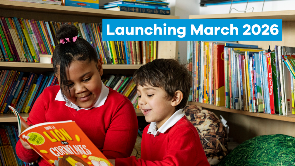 two children in red school jumpers reading Bookbuzz Primary books