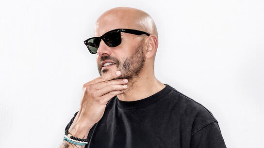 Matt Goodfellow wearing sunglasses and stroking his chin