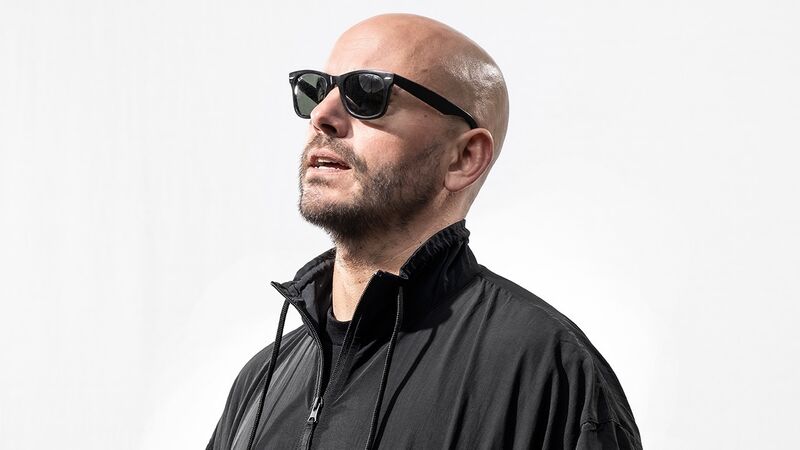 Matt Goodfellow in a black leather jacket and facing upwards towards the sun wearing sunglasses
