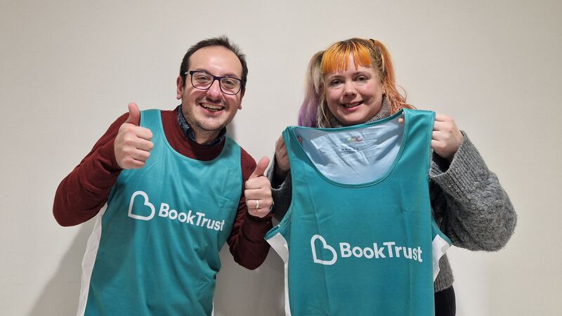 Helen and Francesco smiling with BookTrust teal running vests