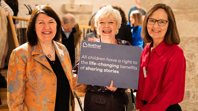 June O'Sullivan, Sue Robb and Alison Morton at the second Reading Rights summit, holding a sign reading "All children have a right to the life-changing benefits of sharing stories"