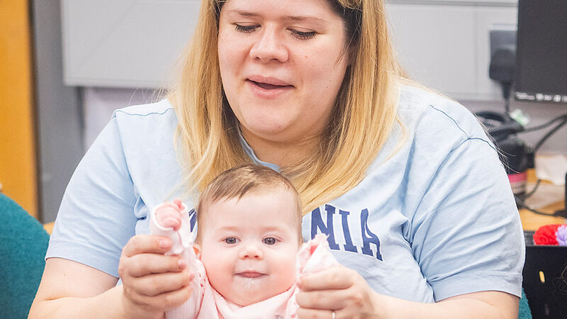 A woman and baby enjoying a rhyme and story time at their library