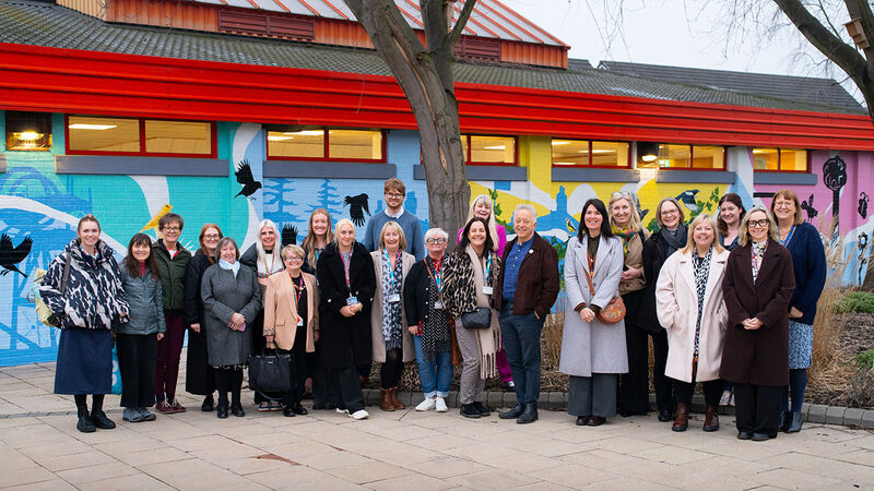 Frank Cottrell-Boyce and practitioners in Barnsley posing outside for a group photo