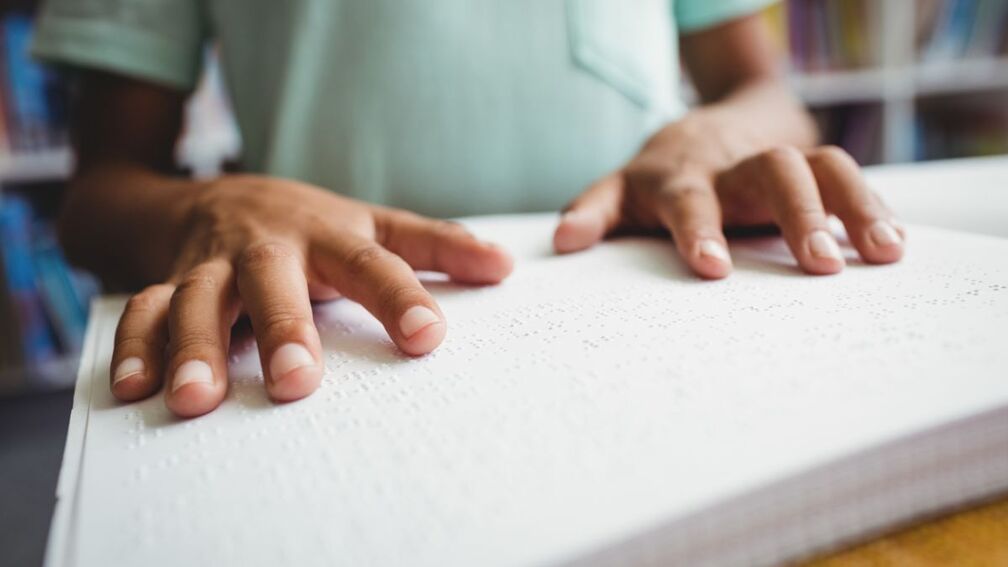A pair of hands reading braille
