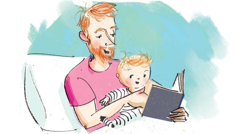 Father and baby reading in bed