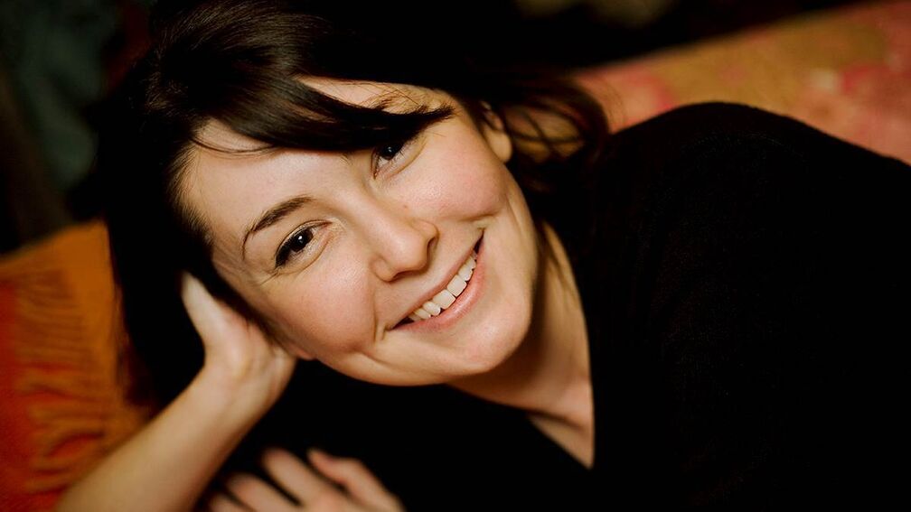 Anna McKerrow looking to camera, smiling.