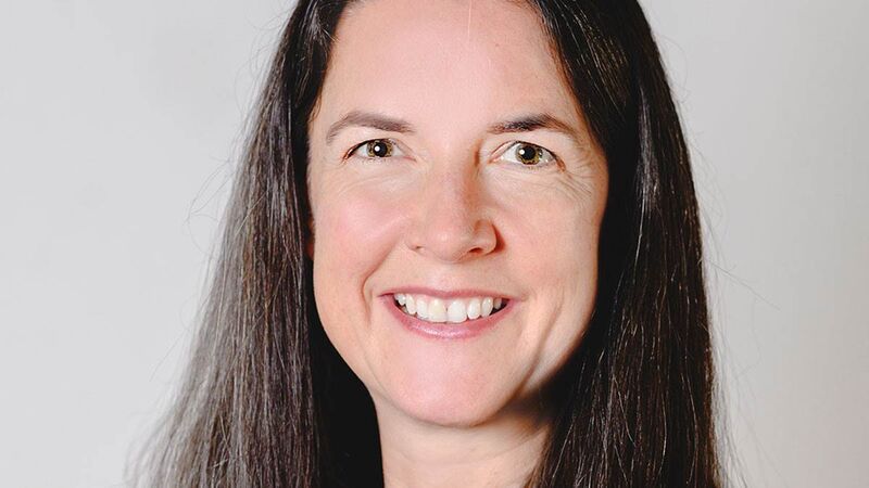 A headshot of Vicki smiling to camera.