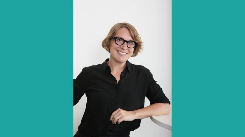 Ellen looking to camera, smiling.