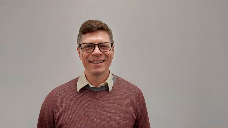 Matthew looking to camera, smiling.