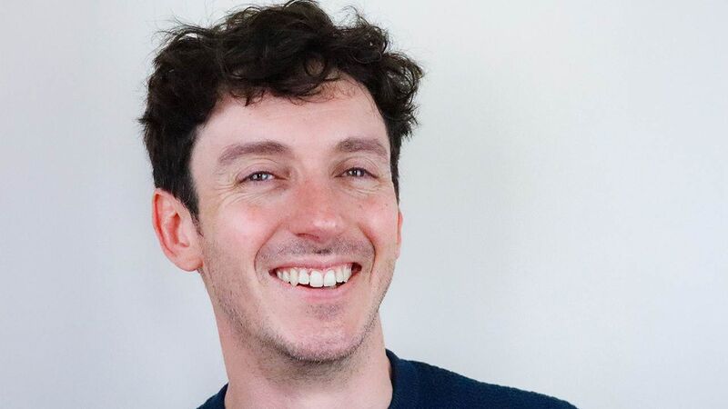 Tim looking to camera, smiling.