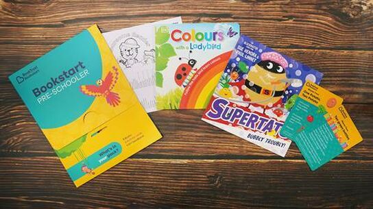 Elements of the Bookstart preschooler pack arranged on a table.