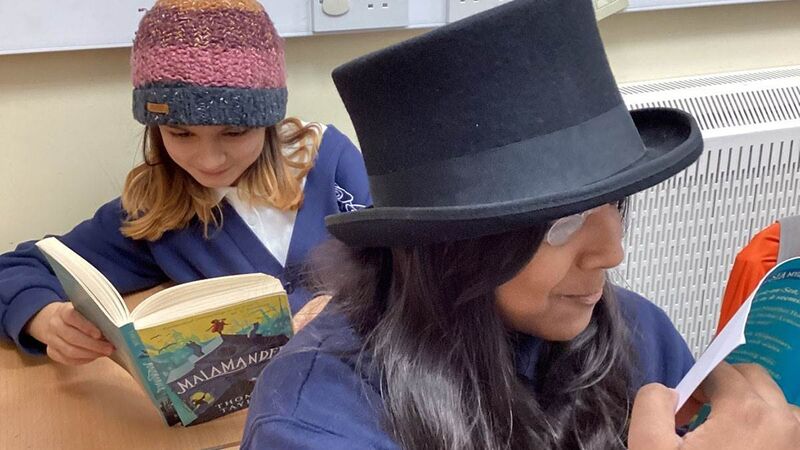 Children wearing hats and reading
