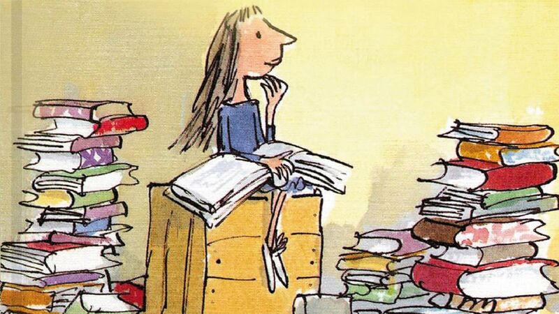 An illustration of a girl, 'Matilda', sat on a pile of books whilst enjoying reading one