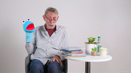 Michael Rosen with a hand puppet.