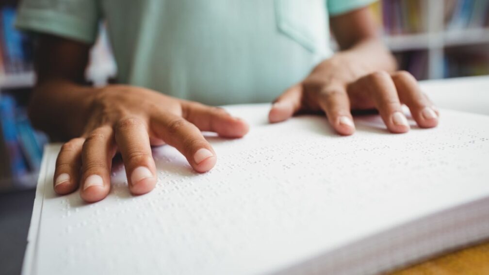 A pair of hands reading braille